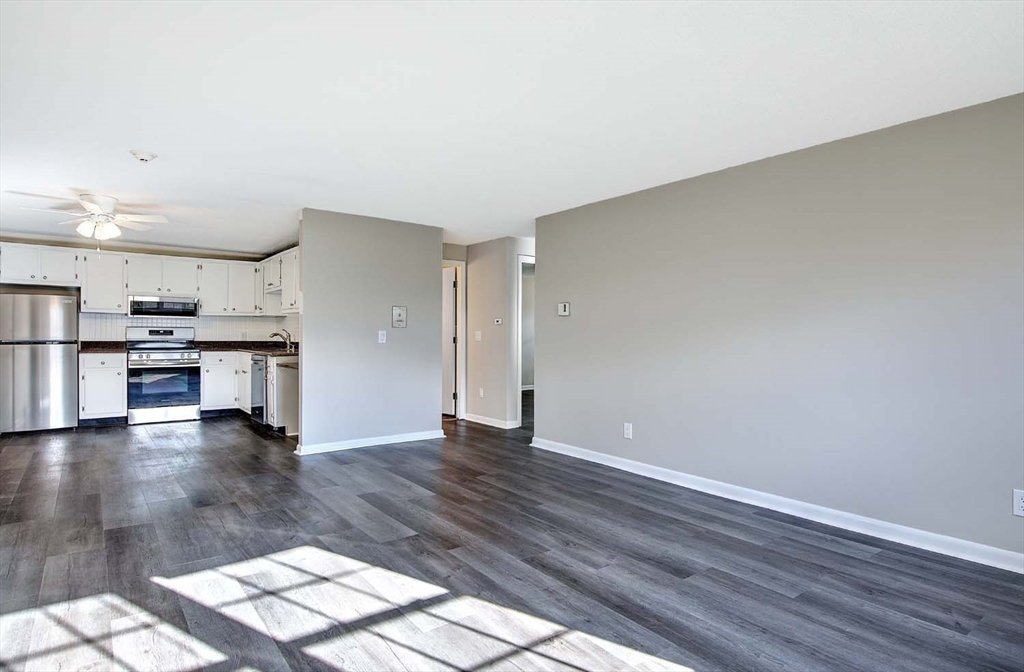 91 Pleasant Street, Unit A6 Medfield, MA 02052 - Photo 7 of 29 a view of kitchen with furniture and wooden floor