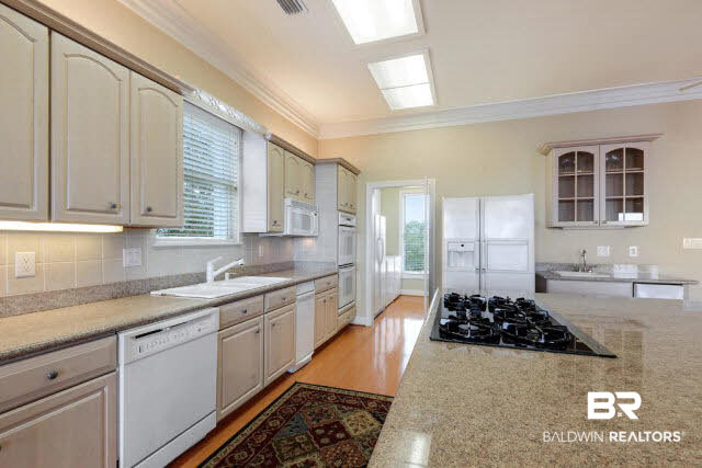 33168 River Road Orange Beach, AL 36561 - Photo 4 of 11 19.3' X 13.11' kitchen with gas range, sunny window above kitchen sink, 8' X 5.7' windowed utility room, 8.11' X 7.1'deep pantry and wet bar Level 2