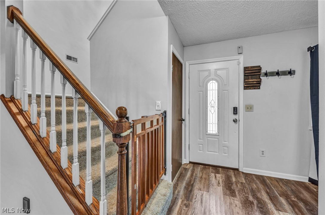 3005 Kendall Road Akron, OH 44321 - Photo 6 of 46 Entrance foyer featuring a textured ceiling and hardwood / wood-style floors