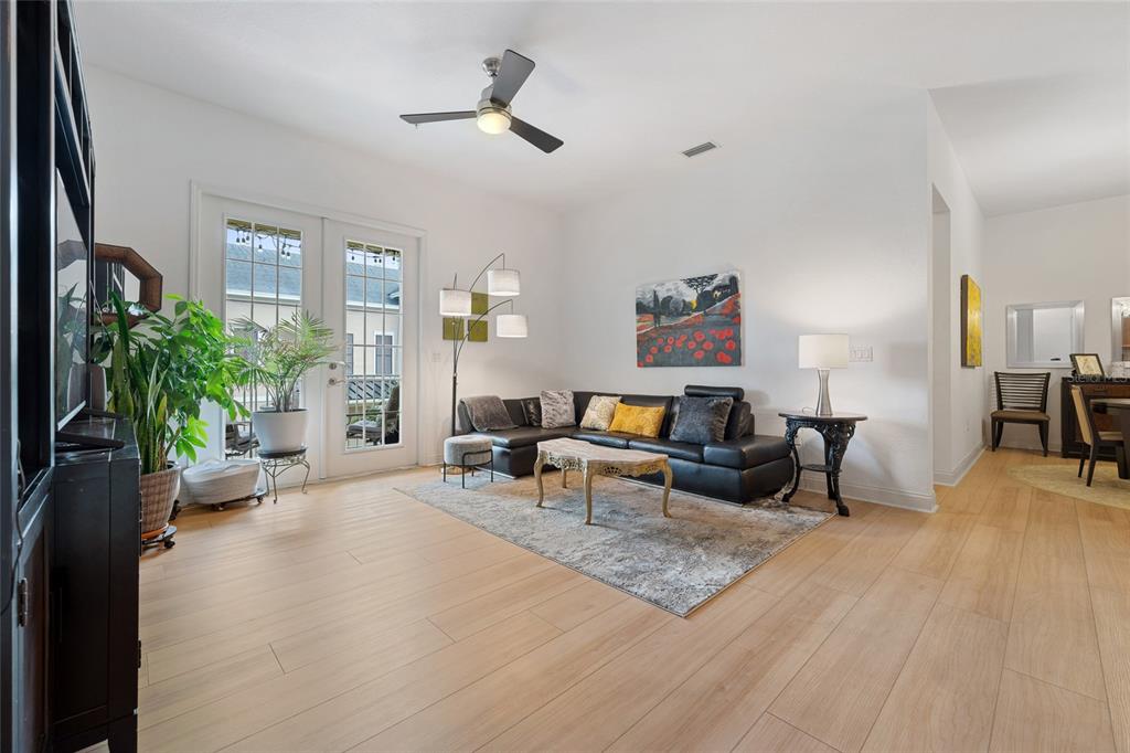 1819 Common Way Road, Unit 203 Orlando, FL 32814 - Photo 11 of 23 a living room with furniture and a potted plant
