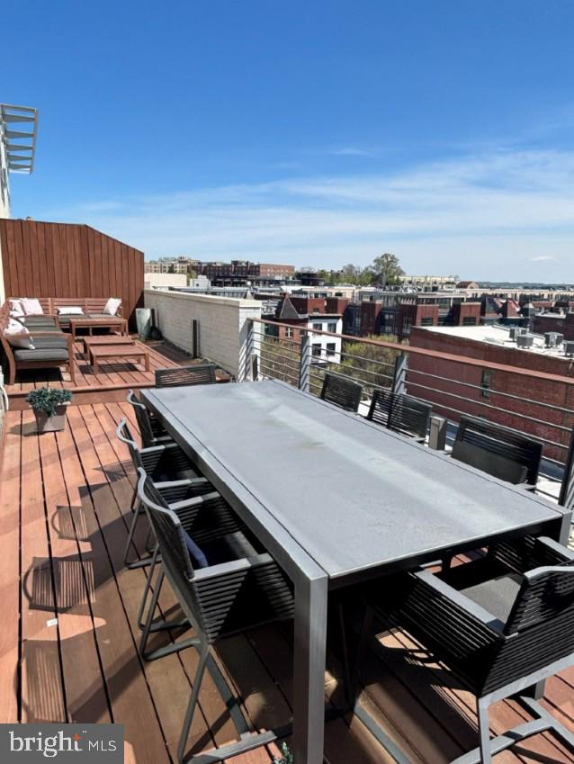 2424 18th Street Northwest, Unit R4 Washington, DC 20009 - Photo 16 of 40 a roof deck with a dining table and chairs with wooden floor