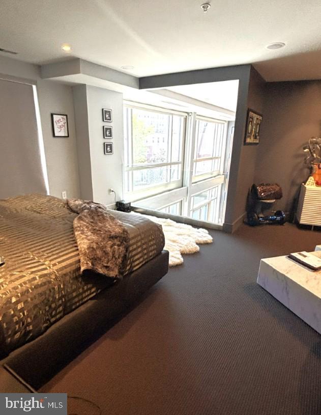 2424 18th Street Northwest, Unit R4 Washington, DC 20009 - Photo 23 of 40 a bed sitting in a bedroom next to a window
