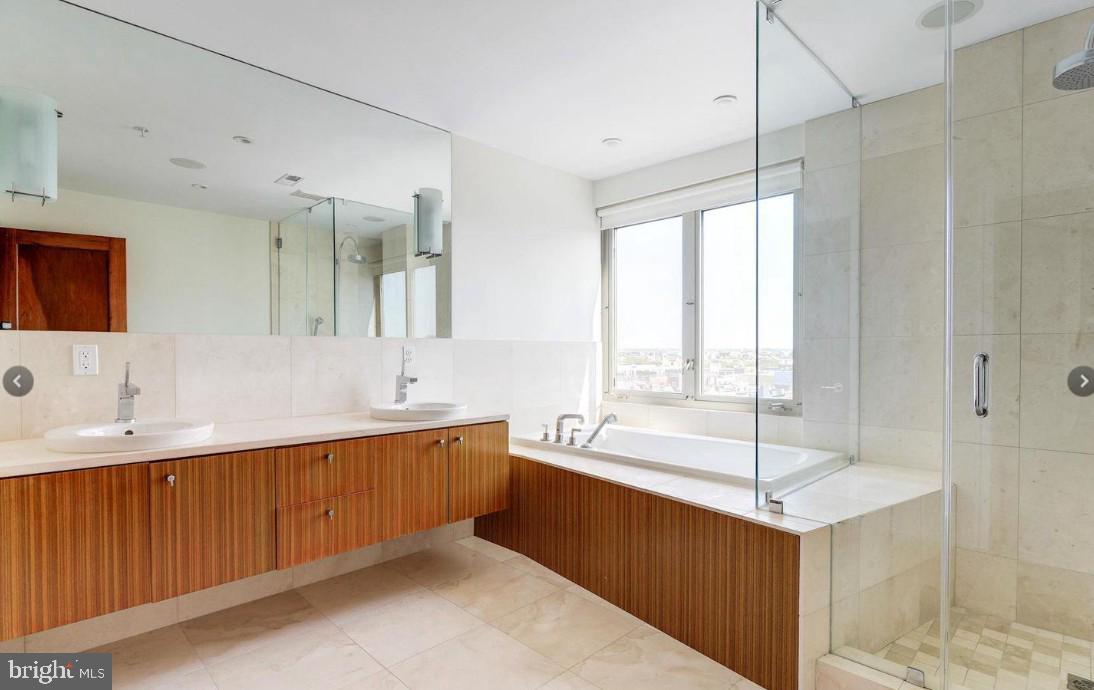 2424 18th Street Northwest, Unit R4 Washington, DC 20009 - Photo 25 of 40 a large bathroom with a large tub sink and mirror