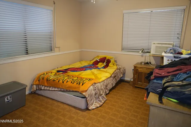 a bed sitting in a bedroom next to a window