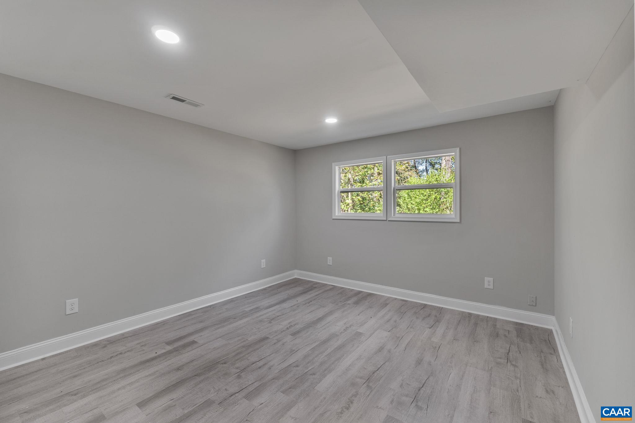 612 Oneals Road Pratts, VA 22731 - Photo 32 of 68 a view of an empty room with wooden floor and a window