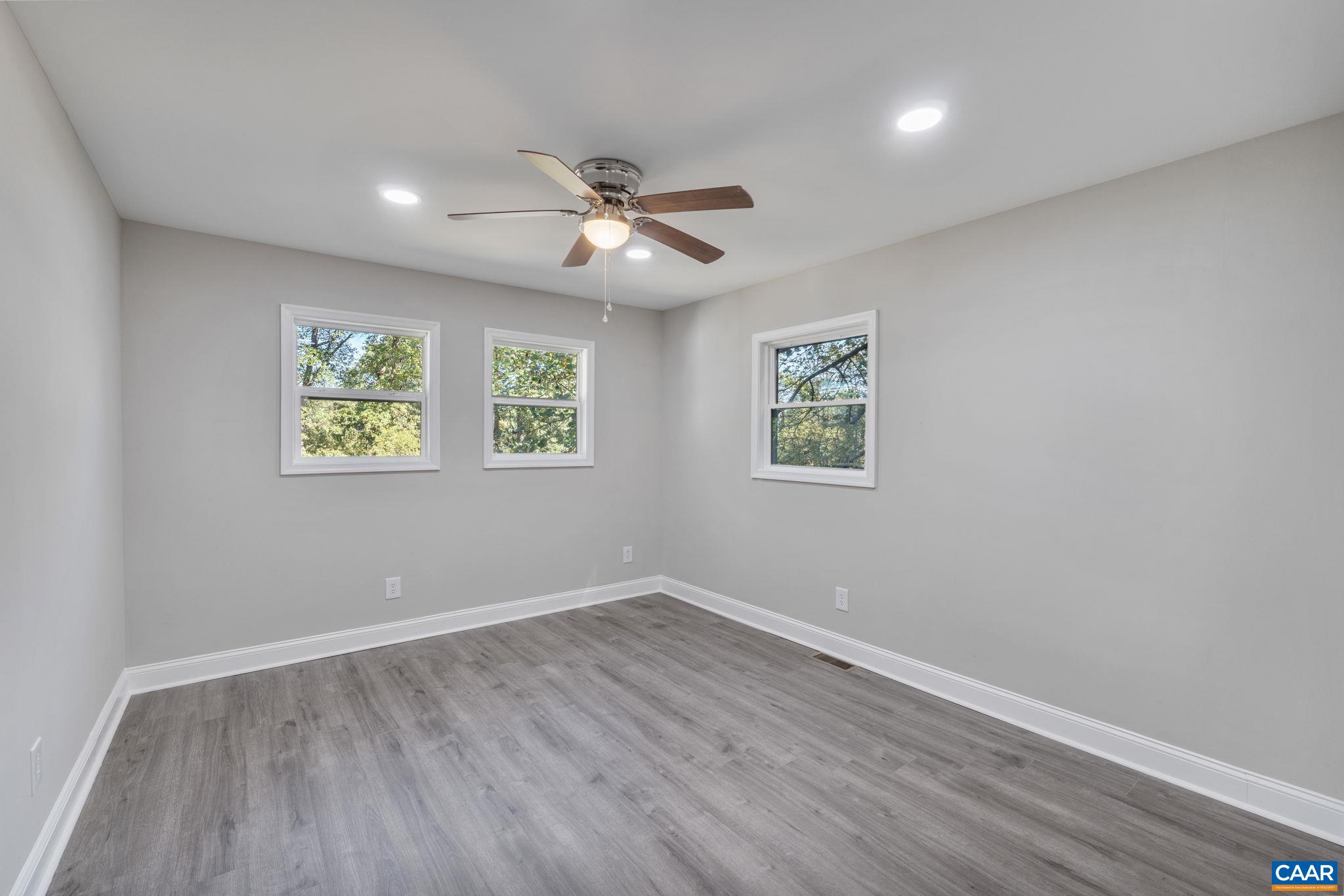 612 Oneals Road Pratts, VA 22731 - Photo 41 of 68 a view of an empty room with wooden floor and a ceiling fan
