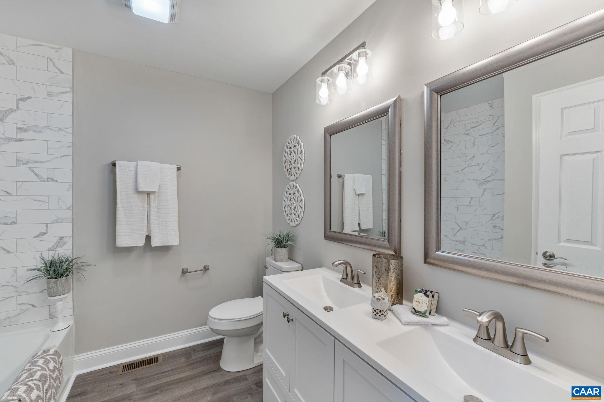 612 Oneals Road Pratts, VA 22731 - Photo 49 of 68 a bathroom with a toilet a sink and mirror