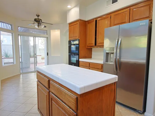 a kitchen with stainless steel appliances a refrigerator and a stove
