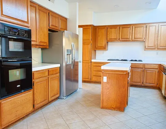 a kitchen with stainless steel appliances granite countertop a refrigerator a stove a sink and dishwasher