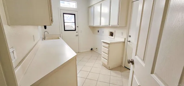 a bathroom with a granite countertop toilet sink and mirror
