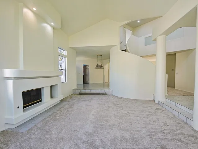 a view of an empty room with a fireplace