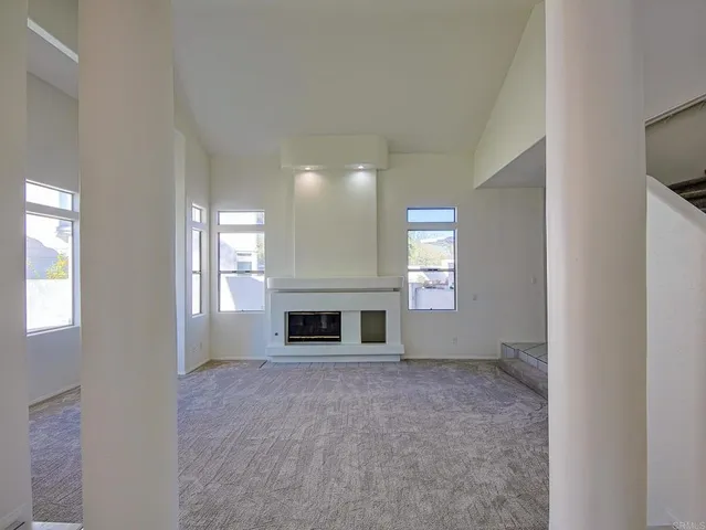 a view of empty room with fireplace