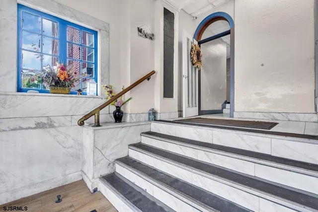 a view of staircase with railing and wooden floor
