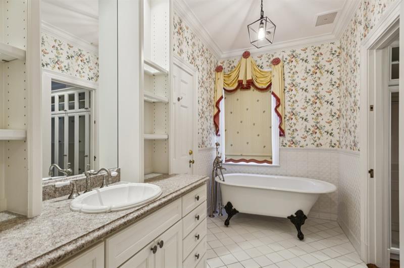 3700 Randall Mill Road Northwest Atlanta, GA 30327 - Photo 35 of 59 a bathroom with a granite countertop sink and a mirror
