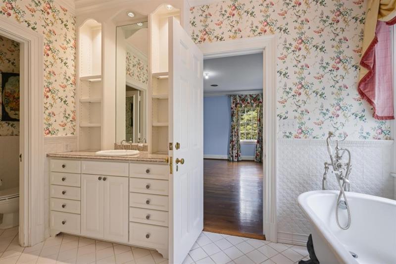 3700 Randall Mill Road Northwest Atlanta, GA 30327 - Photo 36 of 59 a bathroom with a granite countertop sink a toilet and shower