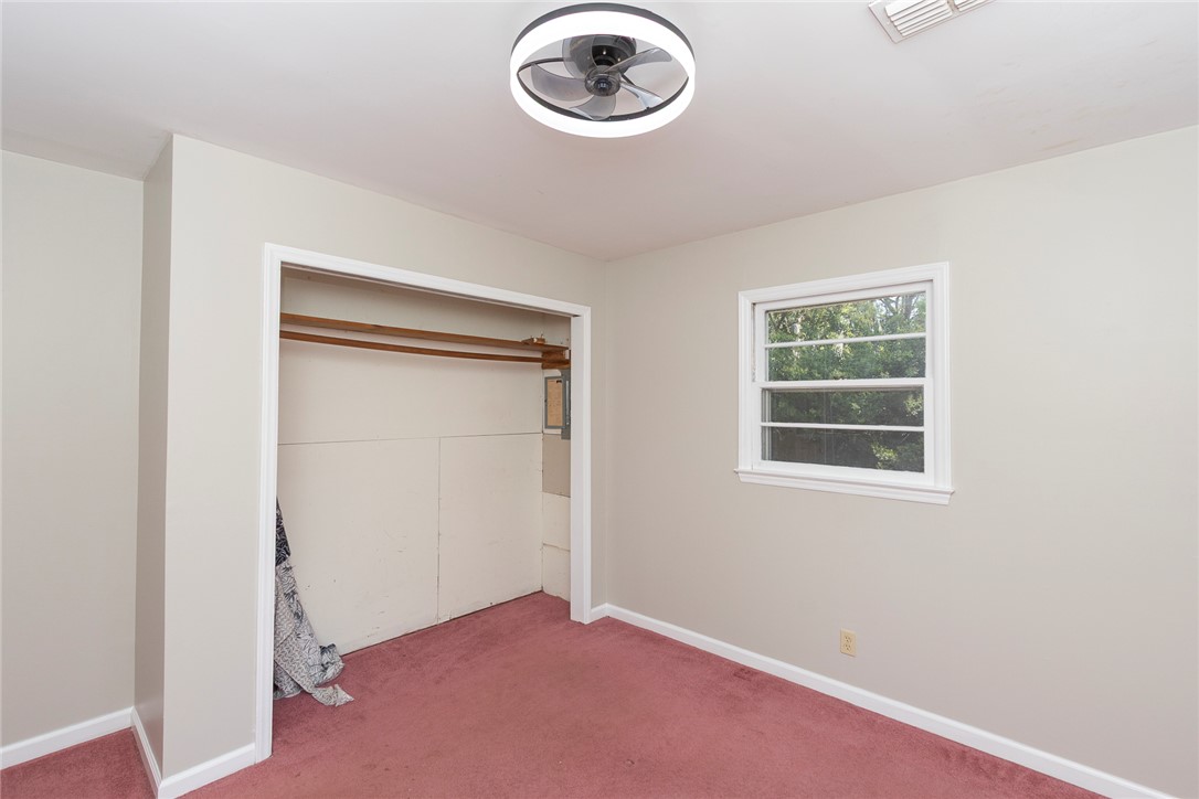 820 Travis Road Anderson, SC 29626 - Photo 29 of 46 This spacious bedroom offers ample natural light and a functional closet for comfortable living.