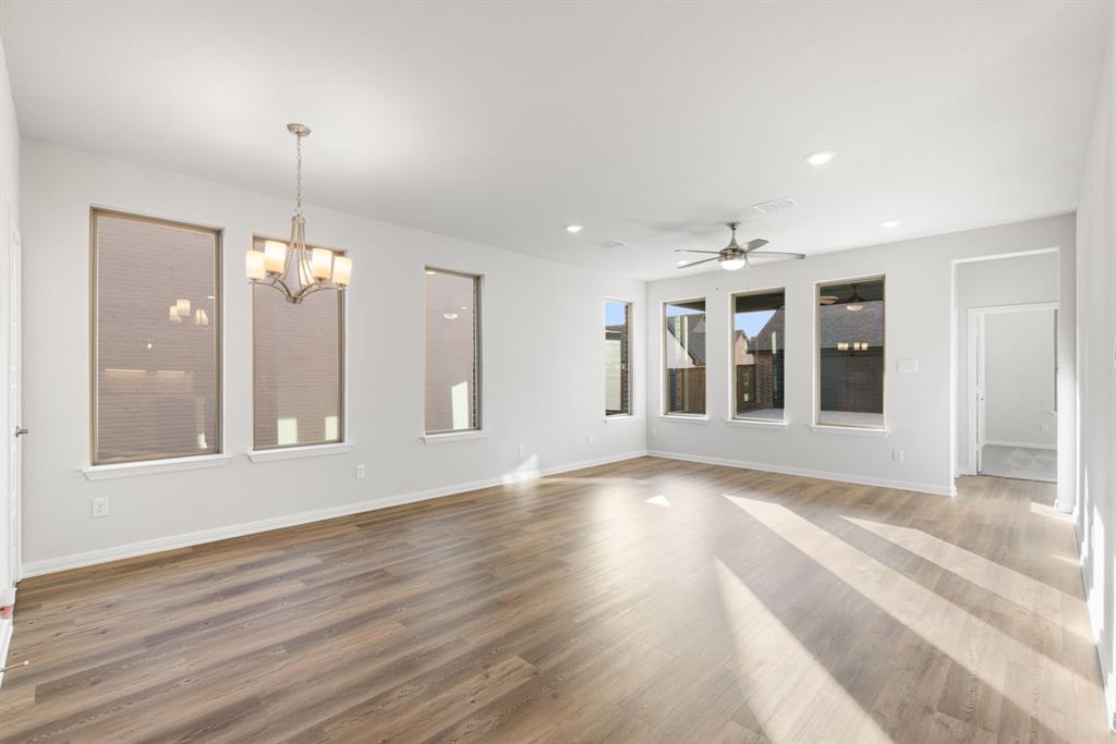 1840 Rosedale Avenue Van Alstyne, TX 75495 - Photo 8 of 26 a view of an empty room with wooden floor and a window