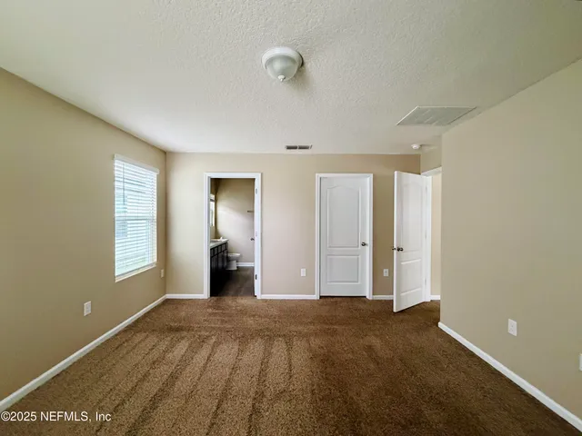 a view of a room with wooden floor and windows