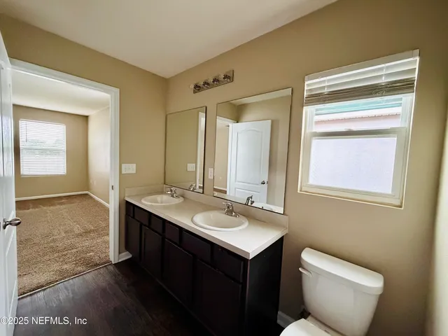 a kitchen with sink a stove and cabinets