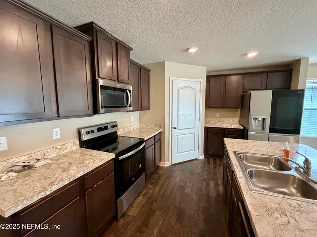 a view of an empty room with window and closet area