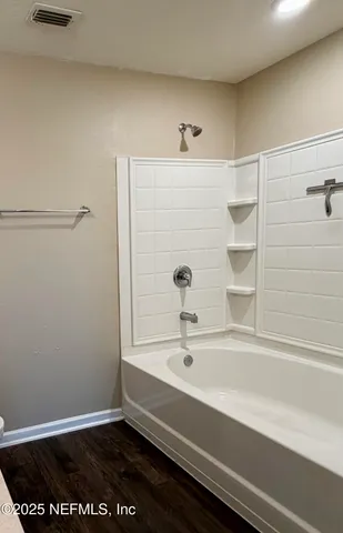 a bathroom with a bathtub and shower