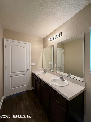 a kitchen with stainless steel appliances granite countertop a sink stove microwave refrigerator and wooden cabinets