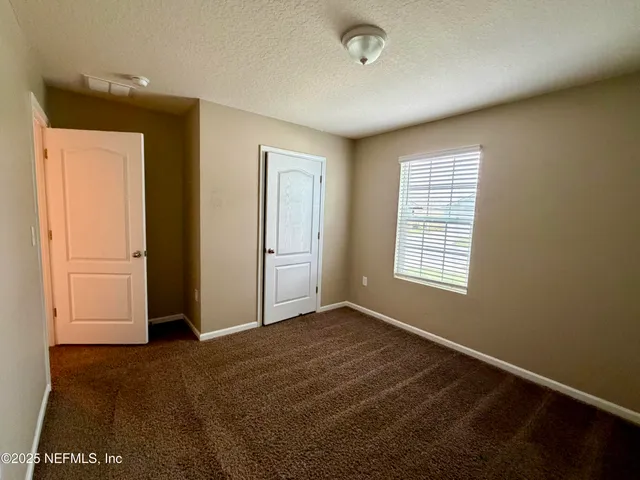 a bathroom with a sink double vanity granite and a mirror
