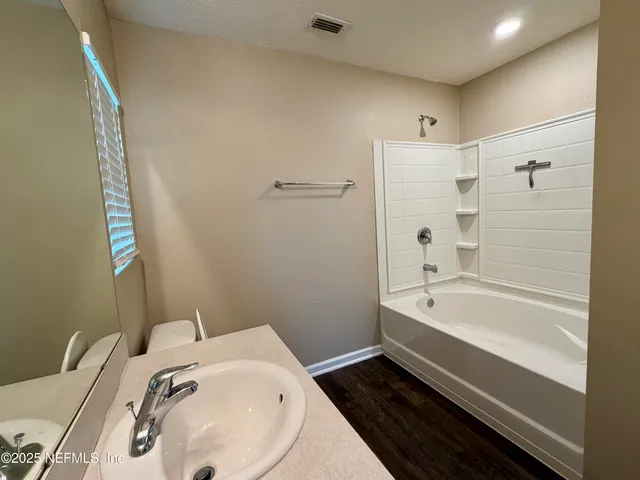 a view of a kitchen with a sink and cabinets