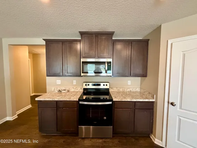 a kitchen with a sink and a stove top oven
