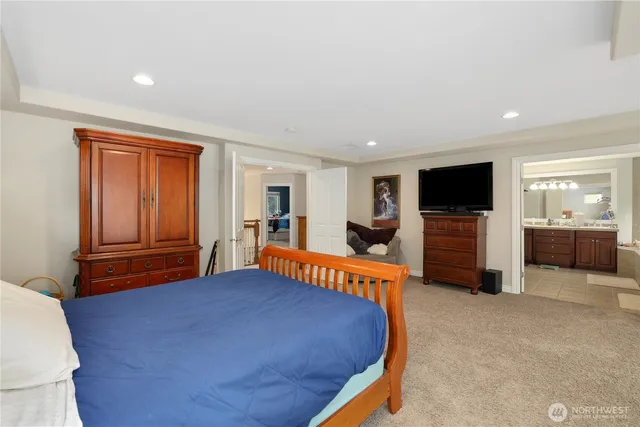 a bathroom with a granite countertop sink mirror bathtub and double