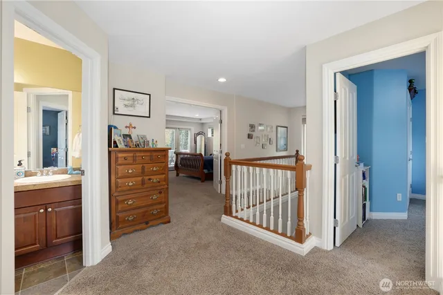 a bathroom with a granite countertop sink vanity mirror and toilet