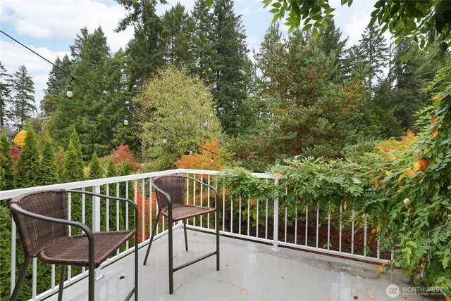 a view of a patio with table and chairs potted plants and large tree