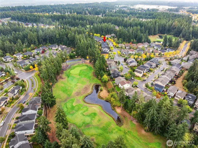 an aerial view of residential houses with outdoor space
