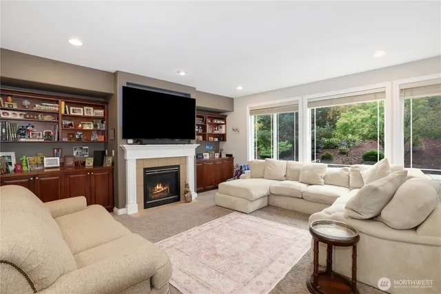 a living room with furniture a fireplace and a flat screen tv