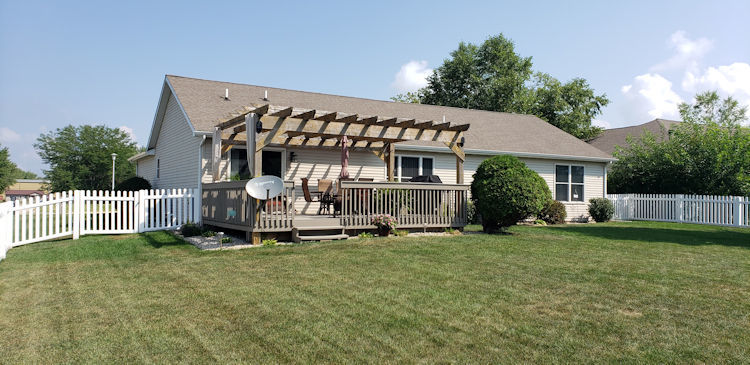 136 Lake Lida Lane Rochelle, IL 61068 - Photo 18 of 19 a front view of a house with a yard and fence