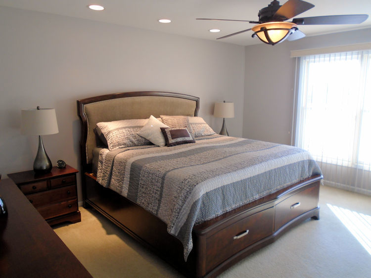 136 Lake Lida Lane Rochelle, IL 61068 - Photo 8 of 19 a bedroom with a bed and a lamp on dresser
