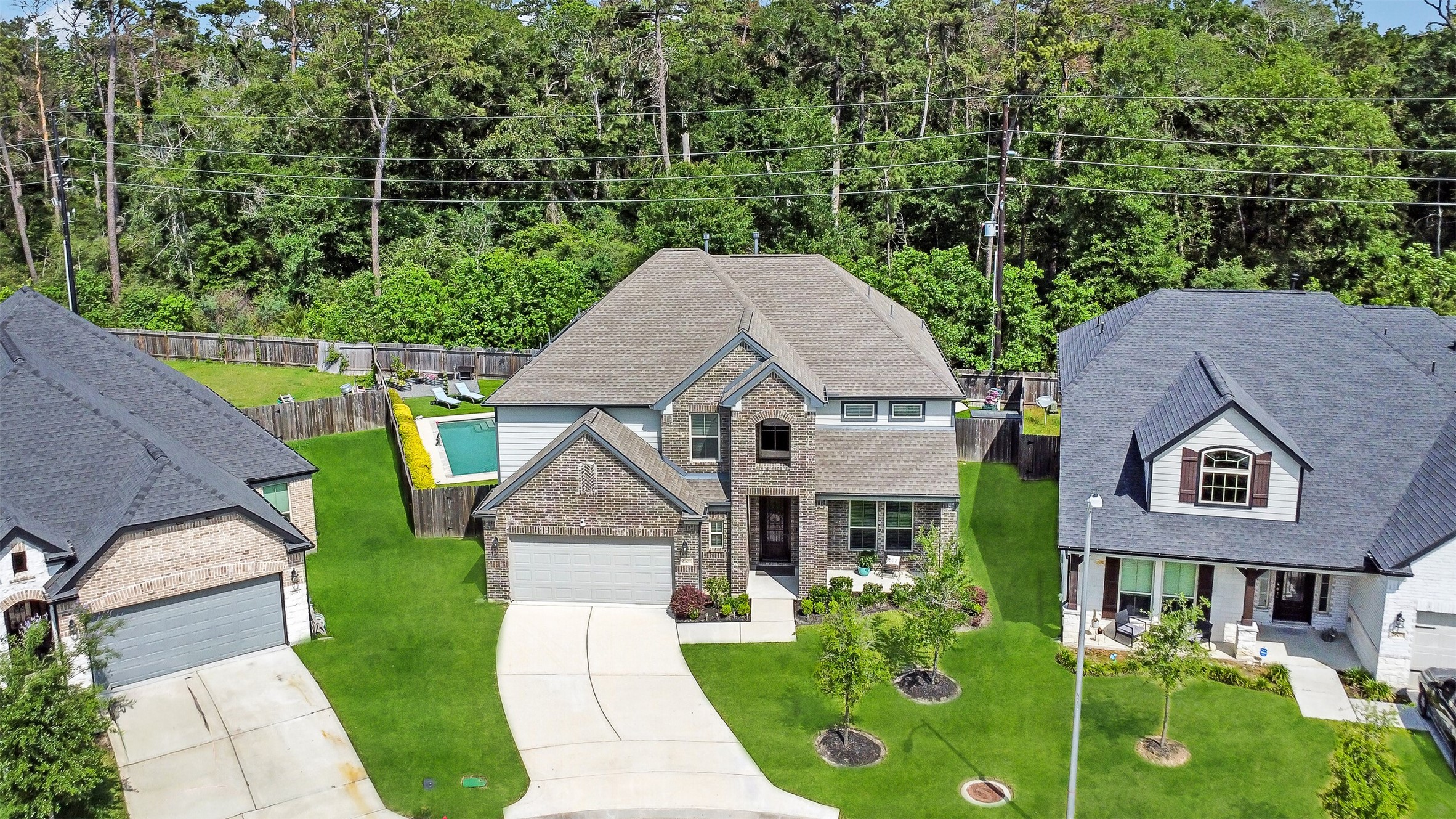 2803 Skerne Forest Dr Spring Spring, TX 77373 - Photo 2 of 44 an aerial view of a house with swimming pool garden and patio
