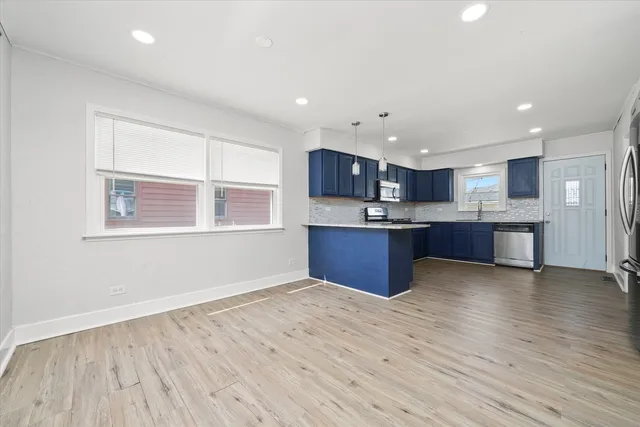 a view with kitchen and wooden floor