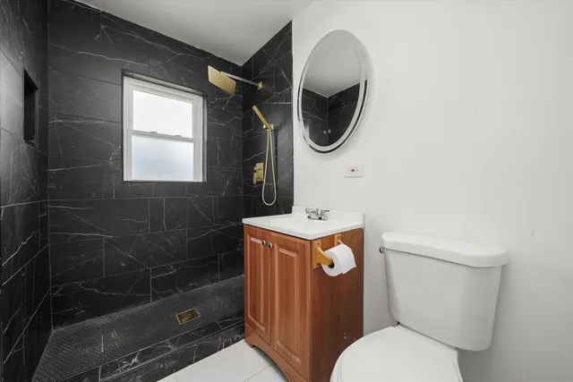 a bathroom with a toilet and a mirror