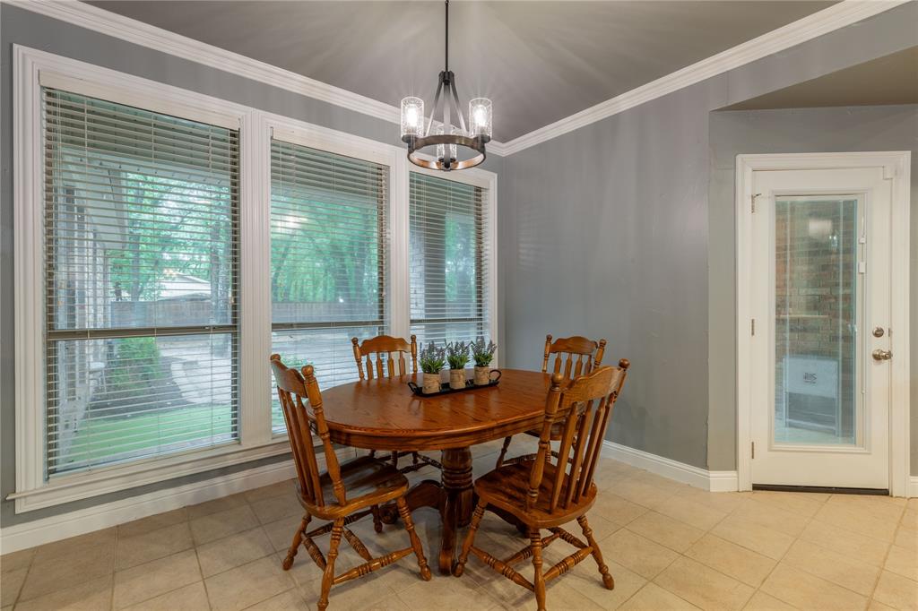 320 Rustic Oaks Road Combine, TX 75159 - Photo 17 of 40 Dining room featuring a chandelier, ornamental molding, and light tile patterned flooring