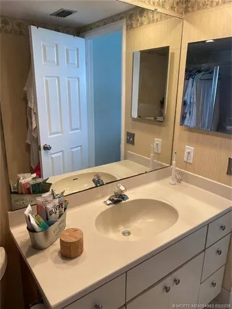 a bathroom with a sink and a mirror