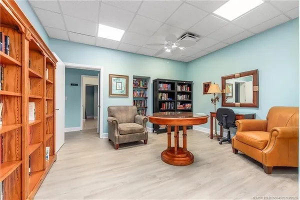a living room with furniture a ceiling fan and a rug