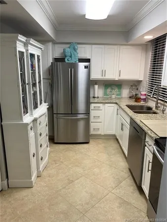 a kitchen with cabinets stainless steel appliances and a sink
