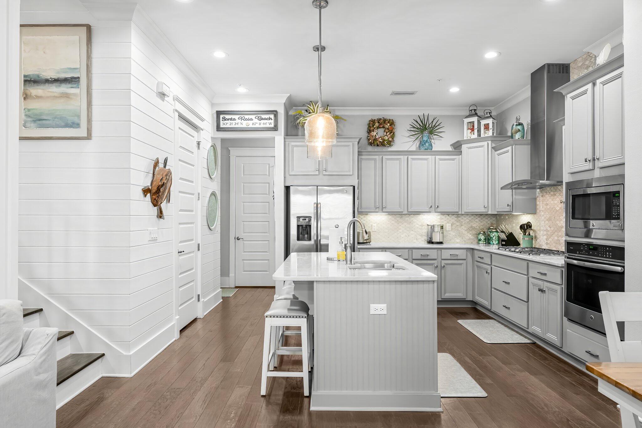 116 Gulfview Way Santa Rosa Beach, FL 32459 - Photo 16 of 59 a kitchen with stainless steel appliances granite countertop a refrigerator a sink dishwasher a stove and white cabinets with wooden floor