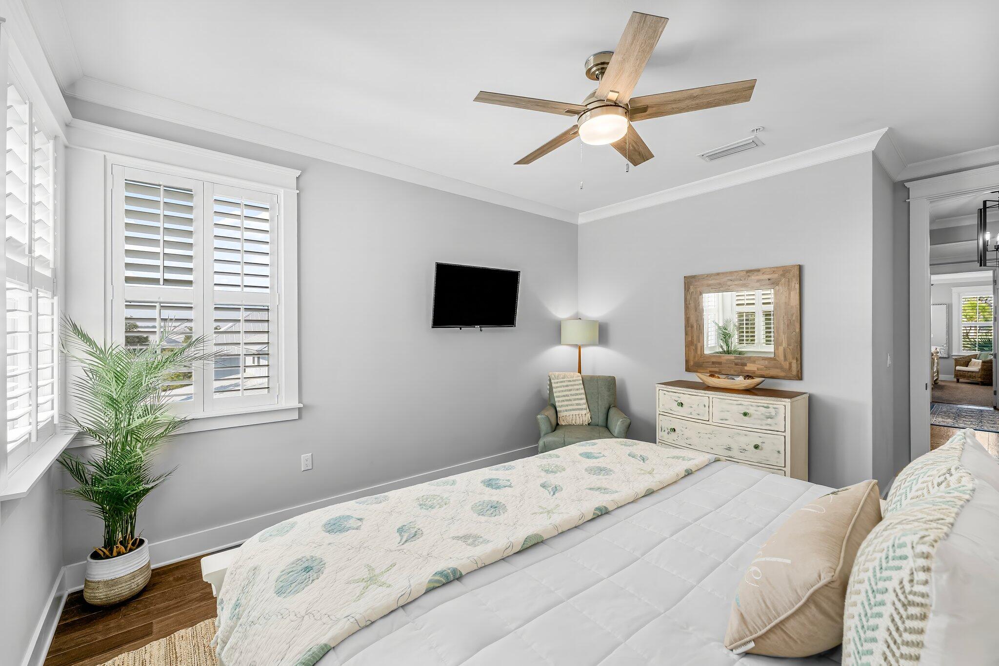 116 Gulfview Way Santa Rosa Beach, FL 32459 - Photo 26 of 59 a bedroom with a large bed a chandelier and a flat screen tv