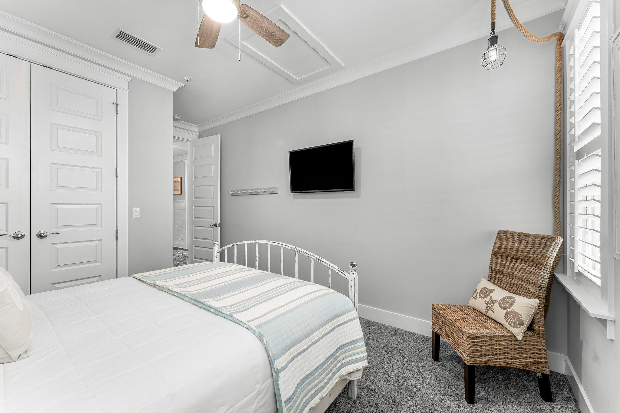 116 Gulfview Way Santa Rosa Beach, FL 32459 - Photo 39 of 59 a bedroom with a bed a flat screen tv and a couch