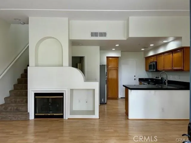 a view of a kitchen with a sink and a fireplace