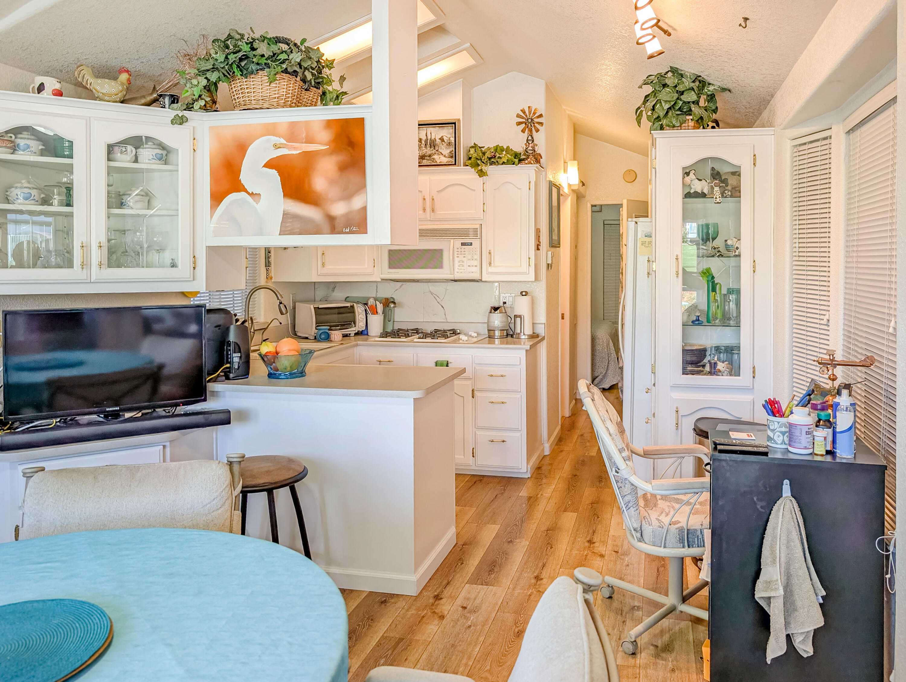 70200 Dillon Road, Unit 493 Desert Hot Springs, CA 92241 - Photo 19 of 35 a living room with furniture a flat screen tv and a floor to ceiling window