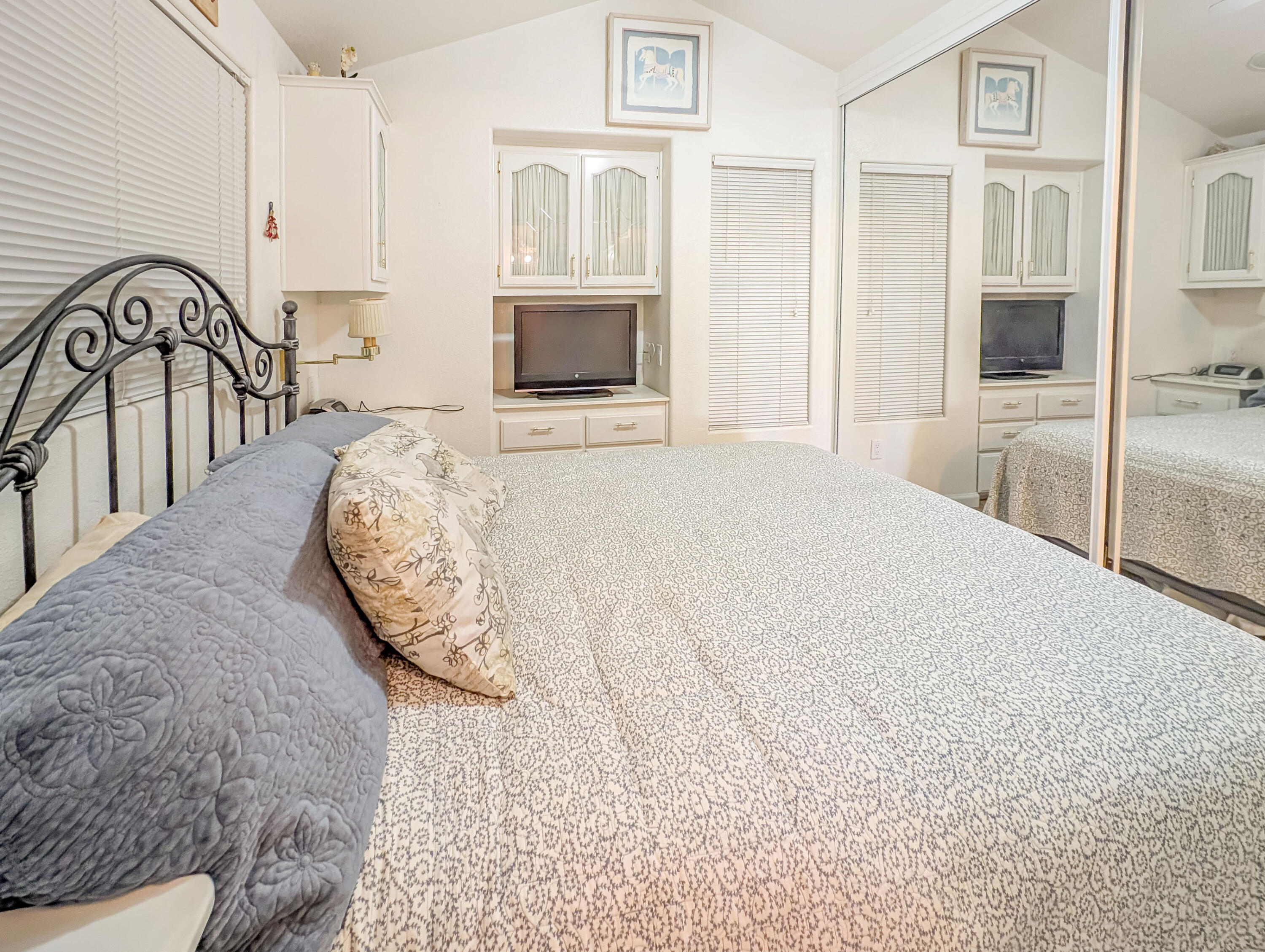 70200 Dillon Road, Unit 493 Desert Hot Springs, CA 92241 - Photo 28 of 35 a bedroom with a bed and a flat screen tv