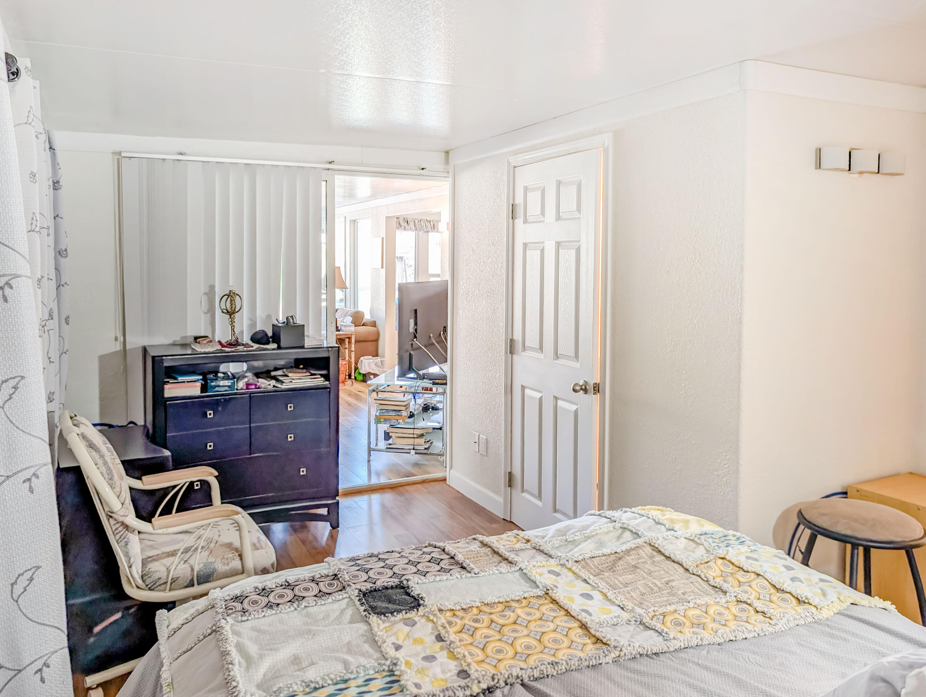 70200 Dillon Road, Unit 493 Desert Hot Springs, CA 92241 - Photo 33 of 35 a bedroom with a bed and wooden cabinets